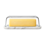 Glass-domed butter dish with a marble base holding a stick of butter.